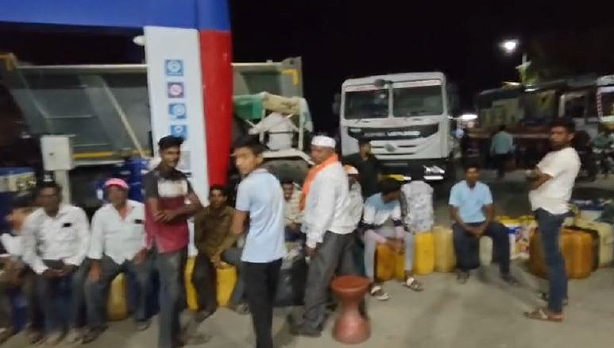 "Eat your fill, then take your fuel..."—Pump owner serves food to people who had been standing in line all day.